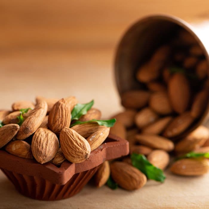 Almonds spilling from a terracotta bowl