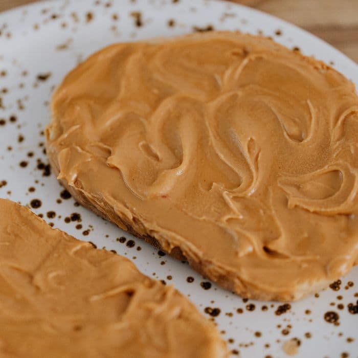 Peanut butter spread thick across a slice of toast